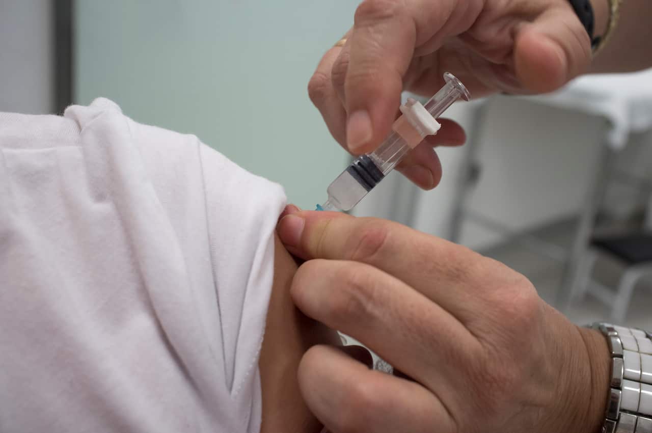 Nurse vaccinating little girl at Healthcare Center