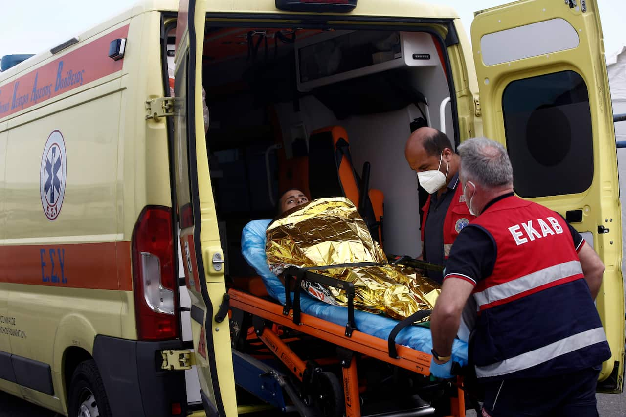 Victim of Greek migrant boat tragedy being loaded into an ambulance