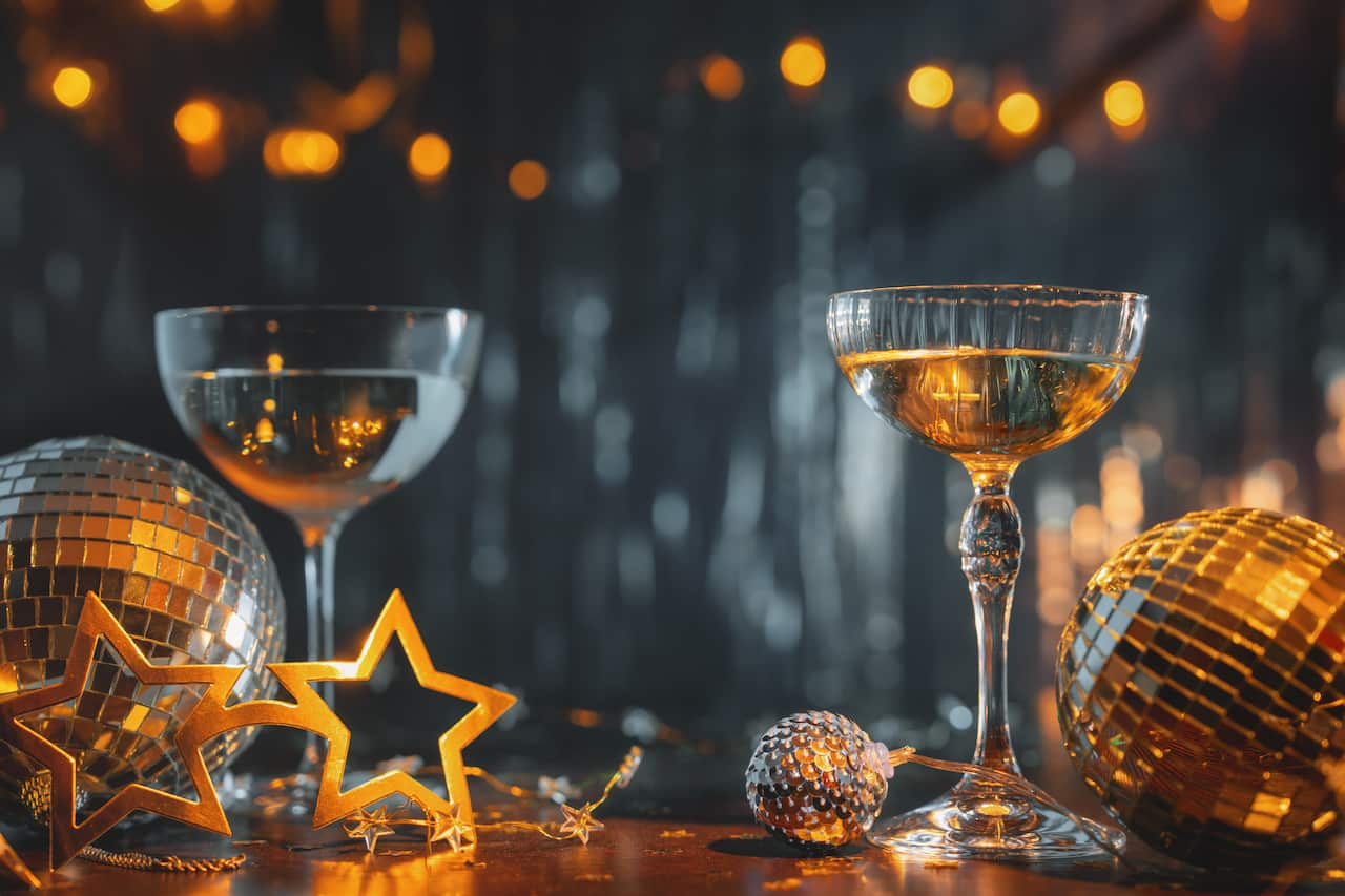 New Year celebration concept with golden lights and champagne flute