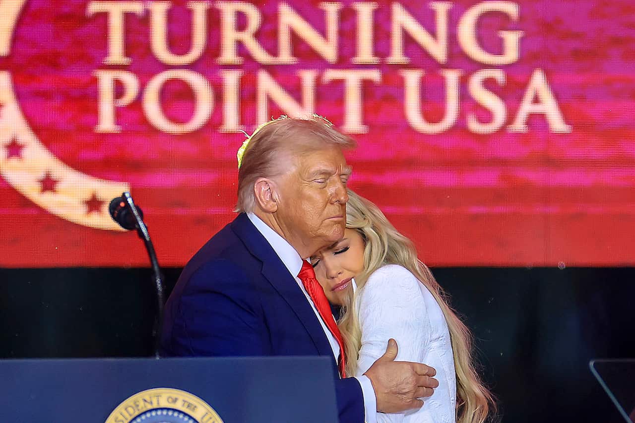 Donald Trump embracing a woman.