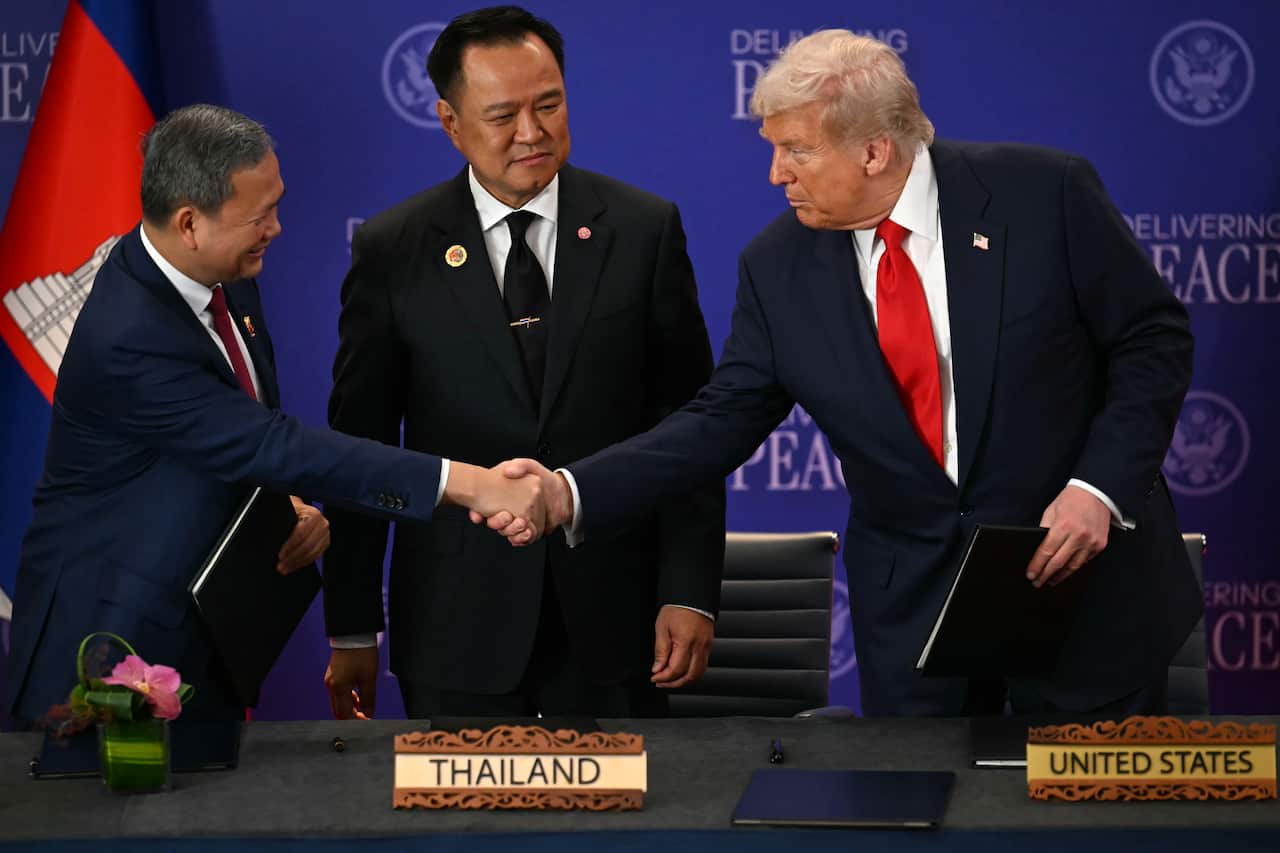 Thailand's Prime Minister Anutin Charnvirakul watches Cambodia's Prime Minister Hun Manet, left, and U.S. President Donald Trump shake hands on the sidelines of the 47th Association of Southeast Asian Nations (ASEAN) summit in Kuala Lumpur, Malaysia
