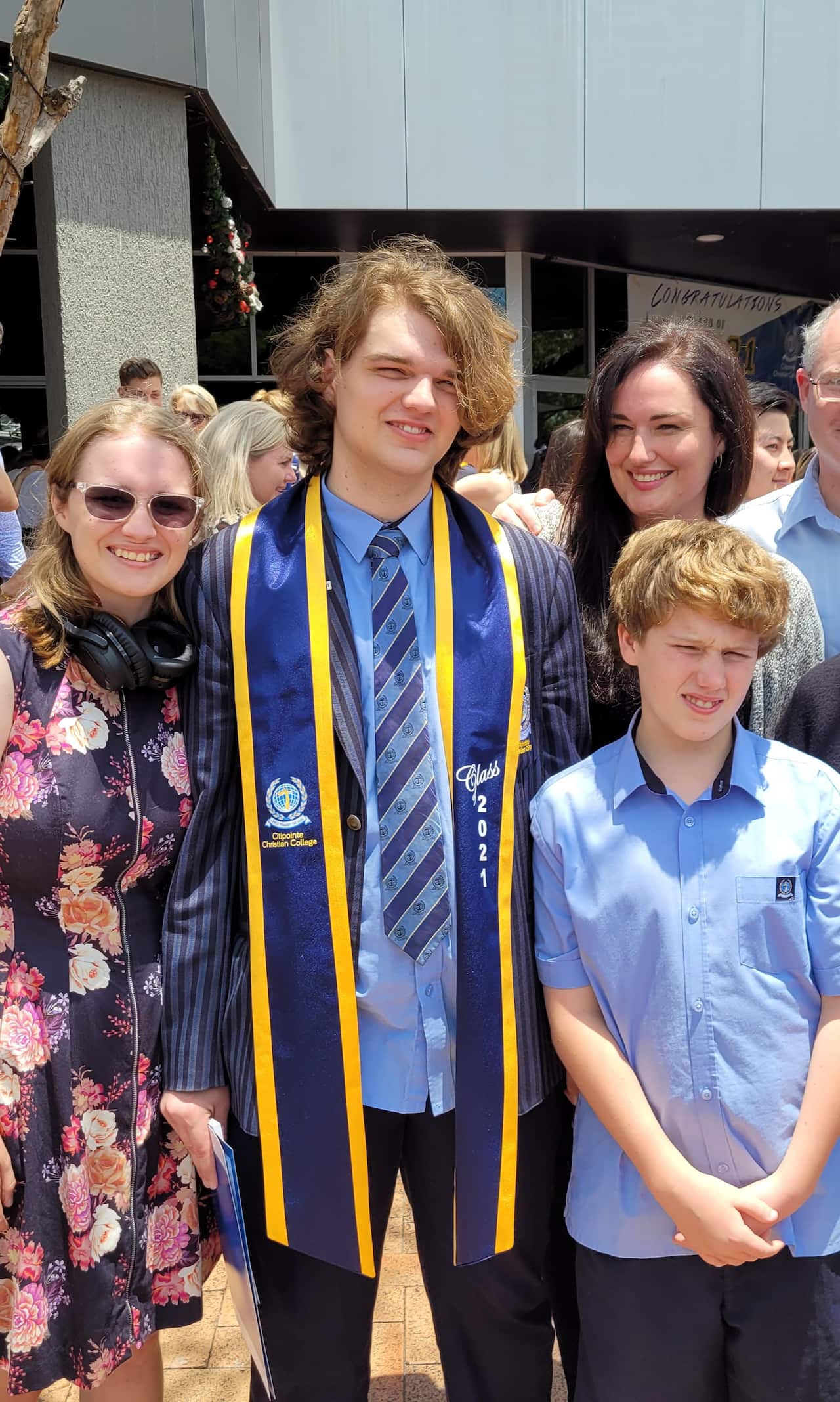 Emmey wearing her school uniform at her Year 12 graduation at Brisbane’s Citipointe Christian College with her siblings and her mother, Janina on the right.