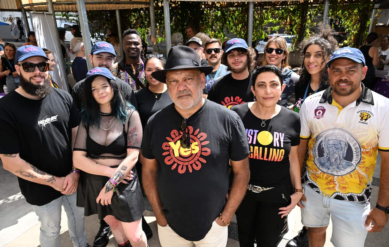 Group of people lead by Noel Pearson wearing shirts promoting the 'Yes' campaign for the Indigenous Voice to Parliament