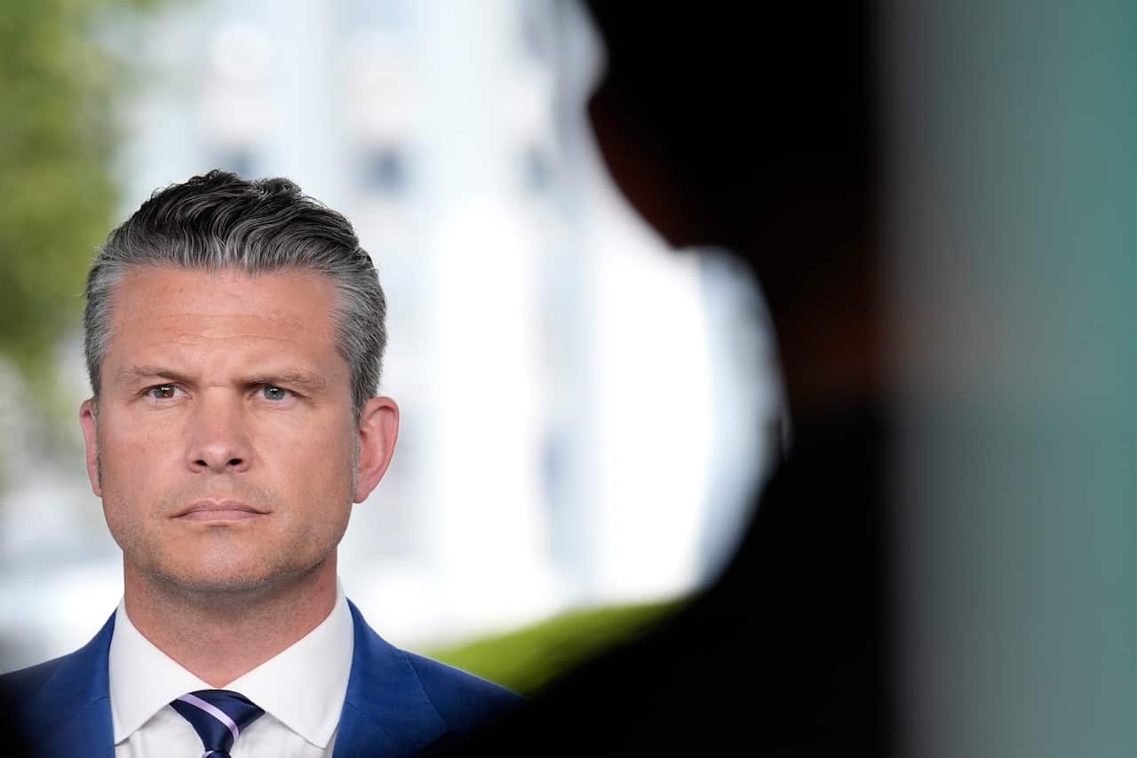 A man in a suit and tie looking solemn