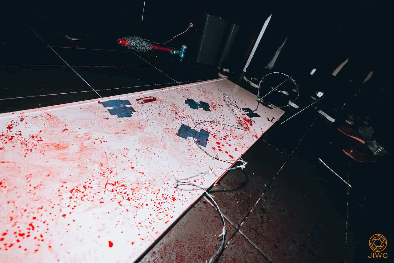 A table with blood and barbed wire on it.
