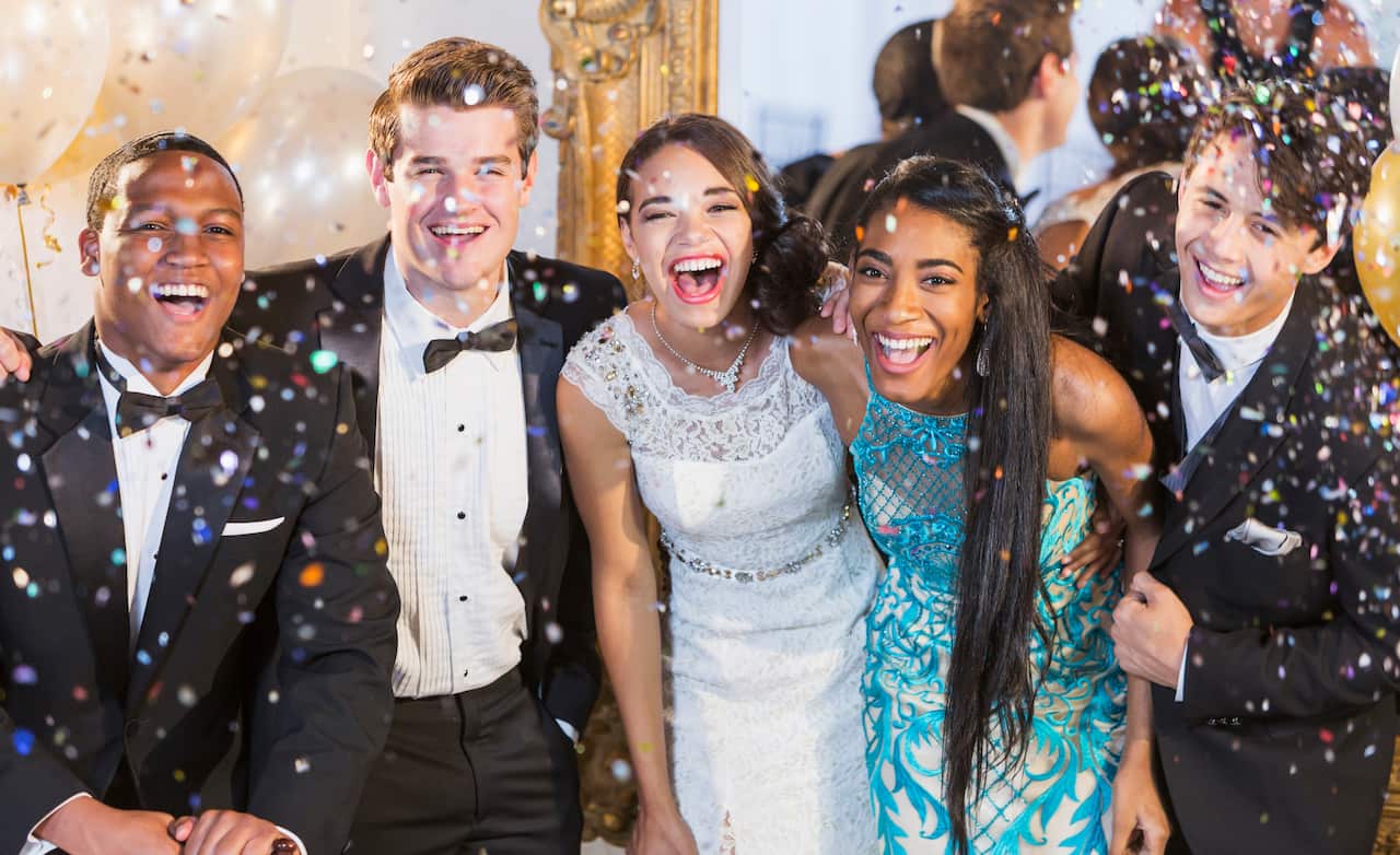 Teenagers and young adults in formalwear at party
