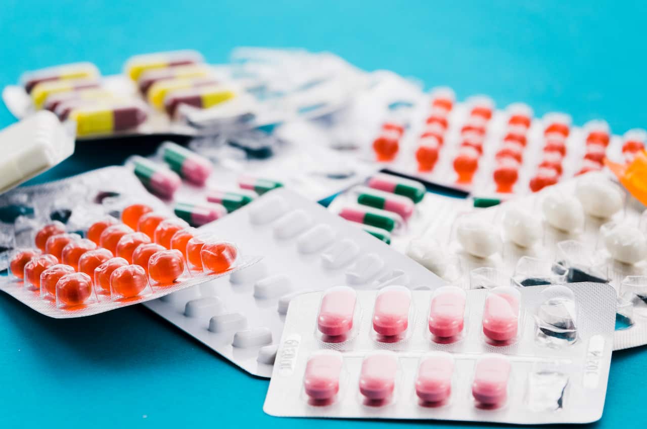 set-various-tablets-capsules-blisters-blue-backdrop.jpg