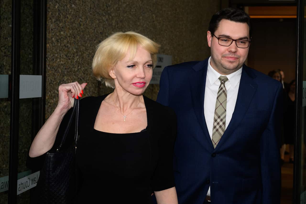 A man and a woman leaving a courthouse