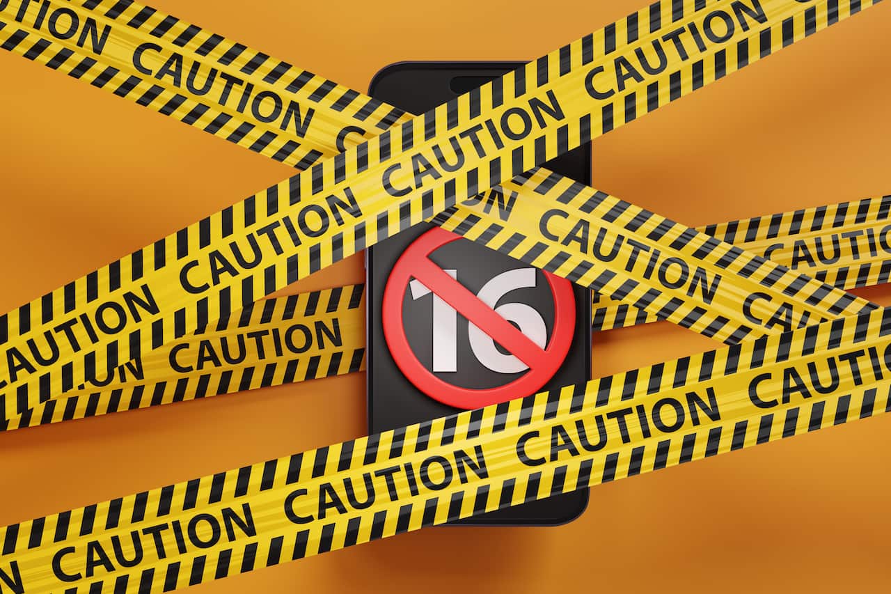 Mobile phone showing the number 16 and a red forbidden sign trapped between barrier tapes on yellow background. Illustration of the British consideration of banning sale of smartphones to under 16s
