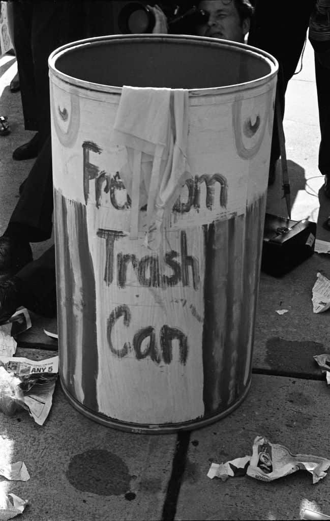 A black and white picture of a bin, painted with the words 'Freedom Trash Can'.