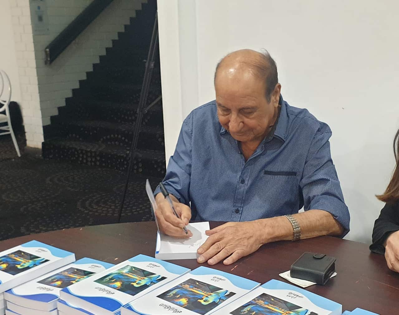 Signing the book