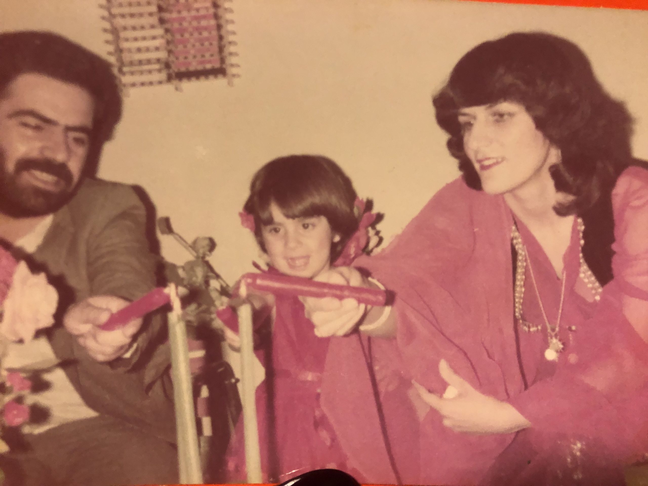 Roza with her parents on her 3rd birthday.