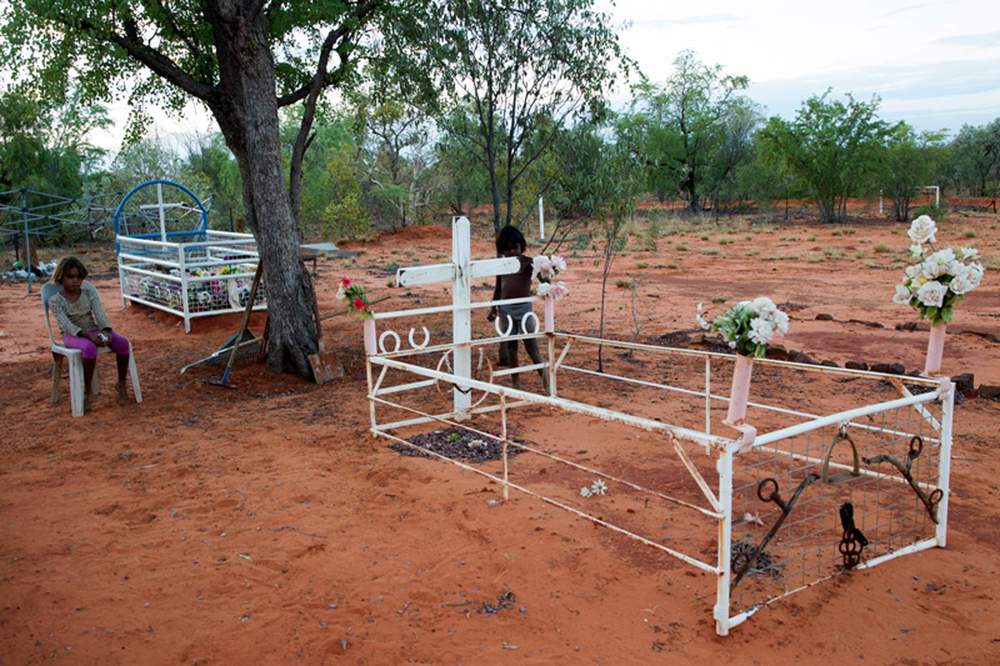 Ngurtuwarta children contemplate Emily Forrest's grave. Ngurtuwarta children contemplate Emily Forrest's grave.