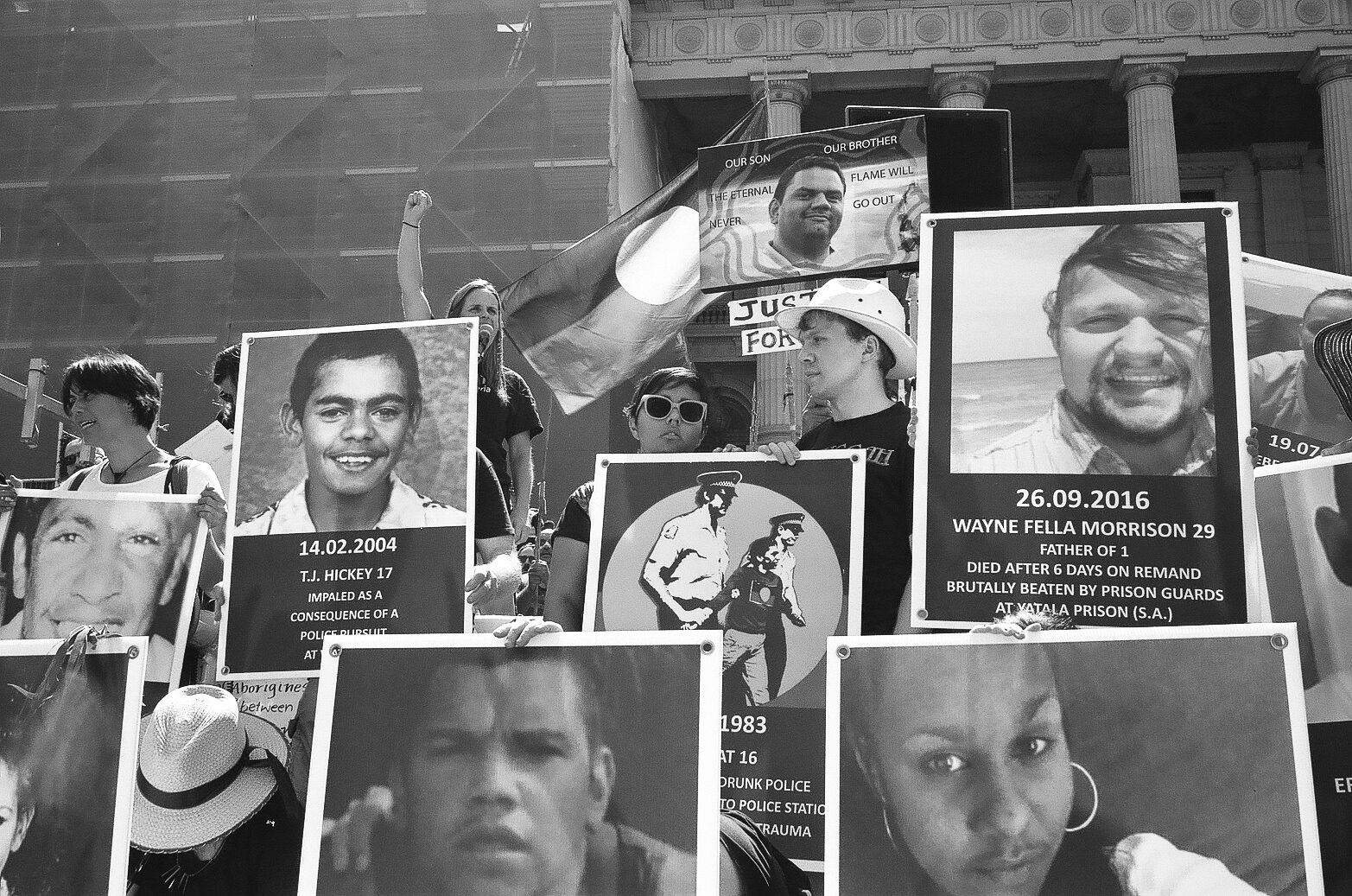 Family members hold placards of people victim to deaths in custody or at the hands of the police. 