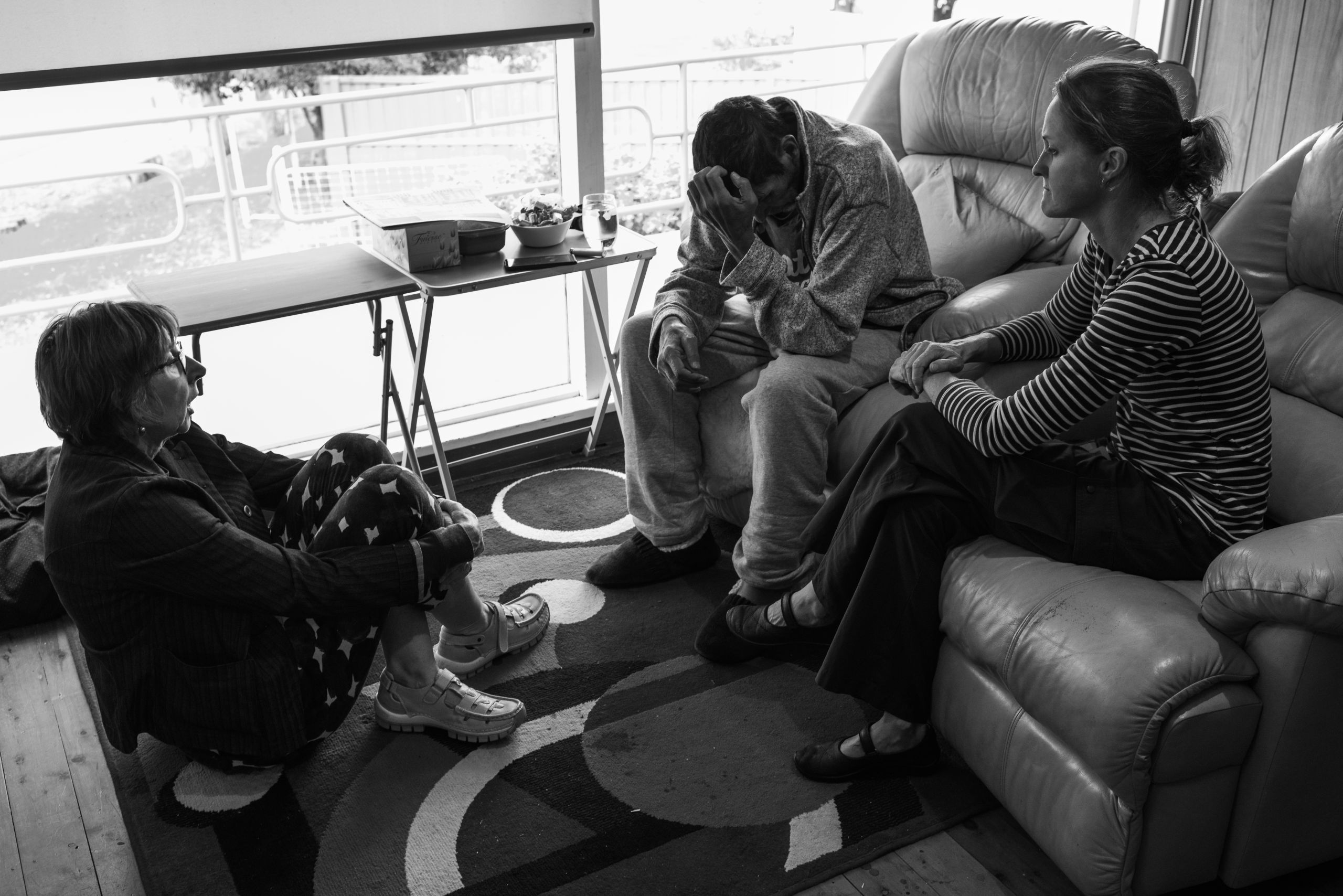 Glen listens as Theresa and Deana relate the diagnosis. For Glen, it is both bad news and good news in that strange kind of way palliative care engenders: bad because the swelling is due to the liver cancer which has continued to grow, good because it is not due to other possible conditions that would treatment in hospital. 10 April 2019. Yuin Country (Central Tilba, NSW).