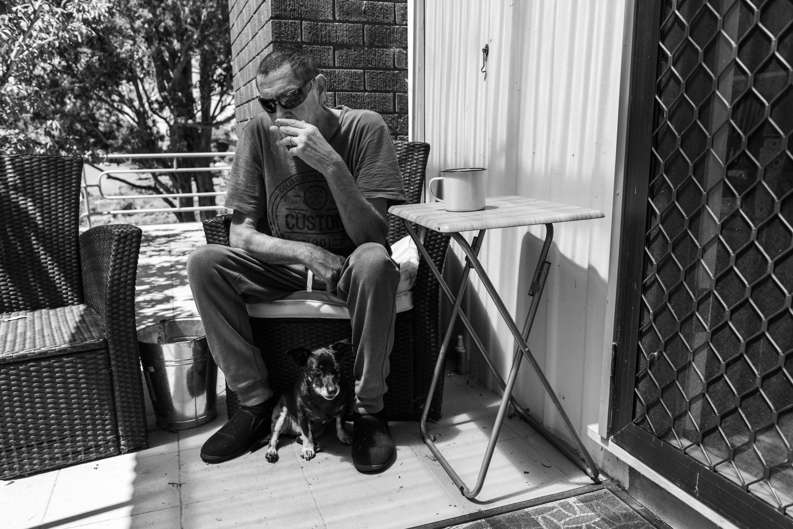 Glen sits in silence with Max on the back veranda. He gave up smoking years before but restarted on the day of his diagnosis. Ironically, Glen is a relatively fit man with healthy lungs. He often joked that he was doing great except for dying from liver cancer. 11 February 2019. Yuin Country (Central Tilba, NSW).