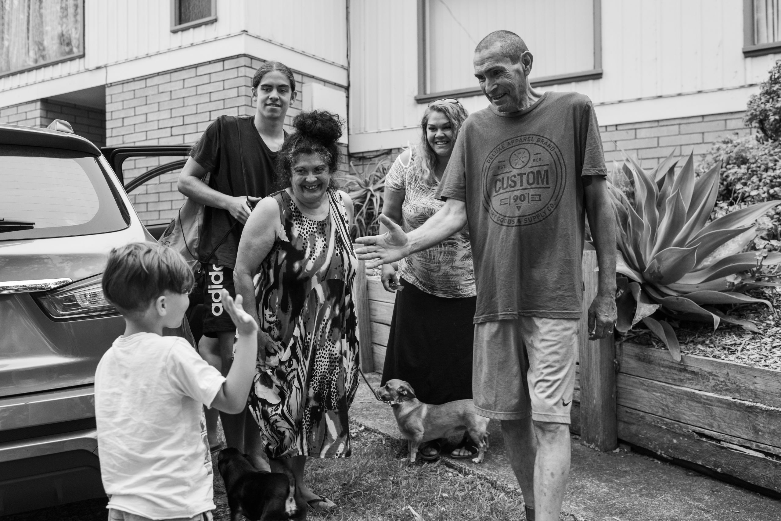 Glen and Merryn greet their daughter, Candice (next to Glen) and grandchildren, Djarmbi (left) and Tyson. They have come to be with family and help complete preparations for Glen's living wake. 16 January 2019. Yuin Country (Central Tilba, NSW).