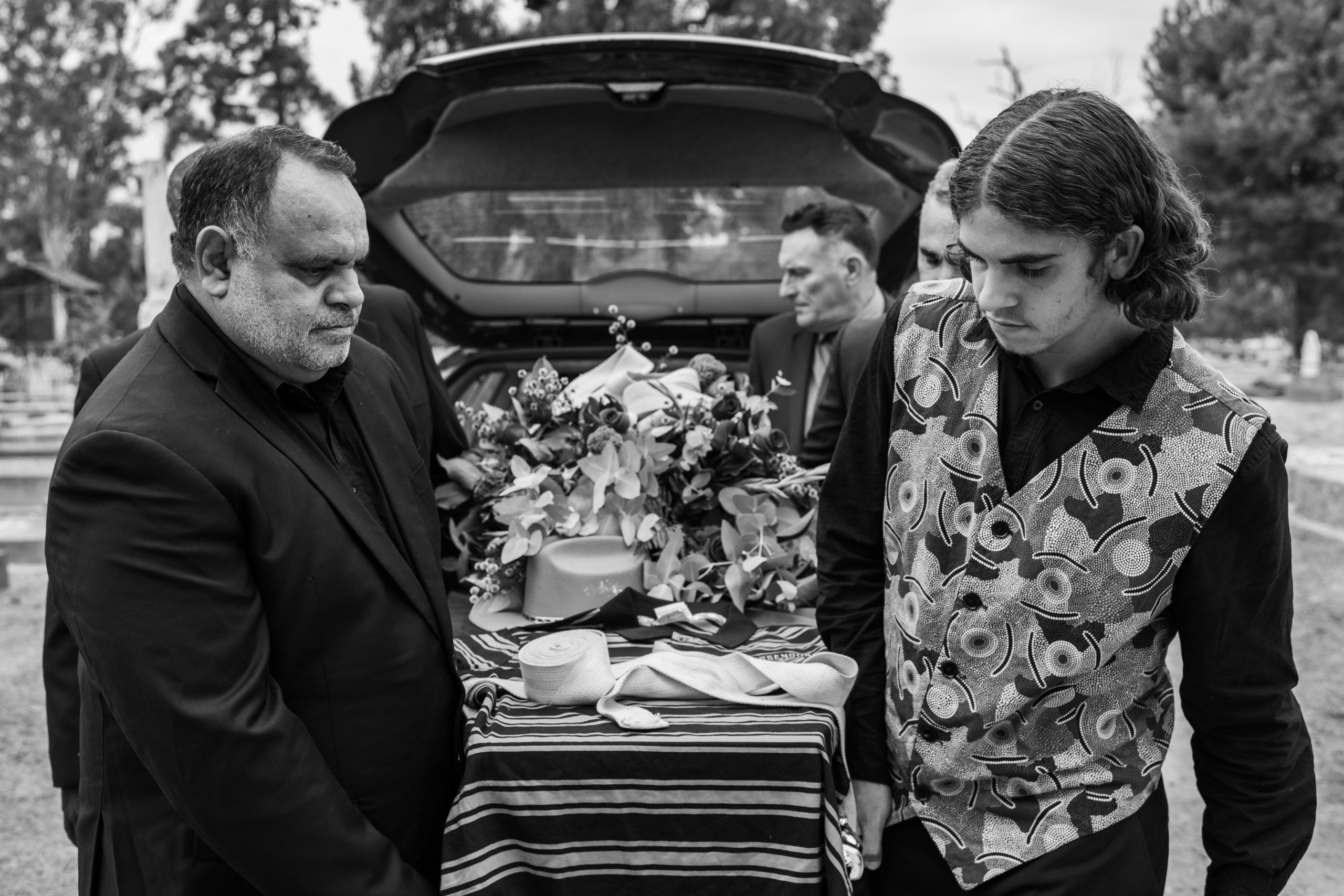 Glen is carried to his grave by his pallbearers: Michael Long (brother), Tyson Edwards (Arrernte/Gunditjmara Man), Ronnie Burns (son, Tiwi Man), Haley Rosenow (niece, Yorta Yorta Woman), Wayne "Buddy" Martin (friend, Kamilaroi Man) and Robbie Oldham (friend). 24 April 2019. Yorta Yorta Country (Echuca, VIC).