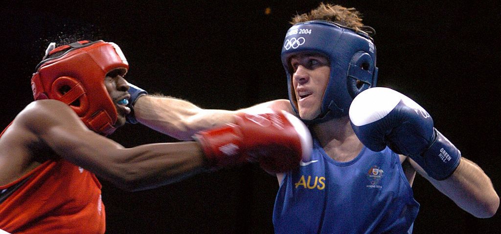 Ron Siler (L) of the USA and Bradley Hore (R) during their Olympic Games preliminary Fly (51) match at the Peristeri Boxing Hall 17 August 2004 in Athens. JOE KLAMAR/AFP via Getty Images