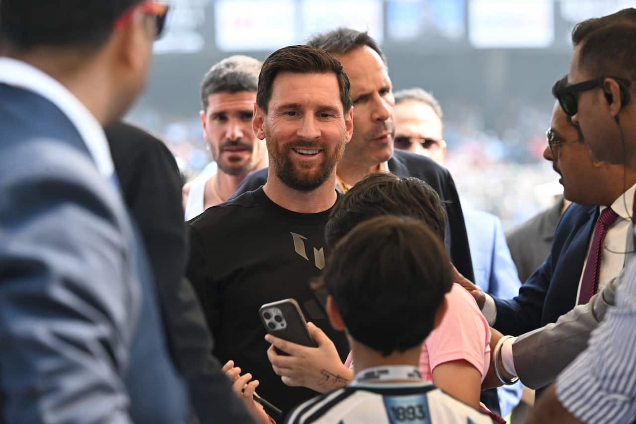 A fan takes a selfie with Inter Miami's Argentine forward #10 Lionel Messi