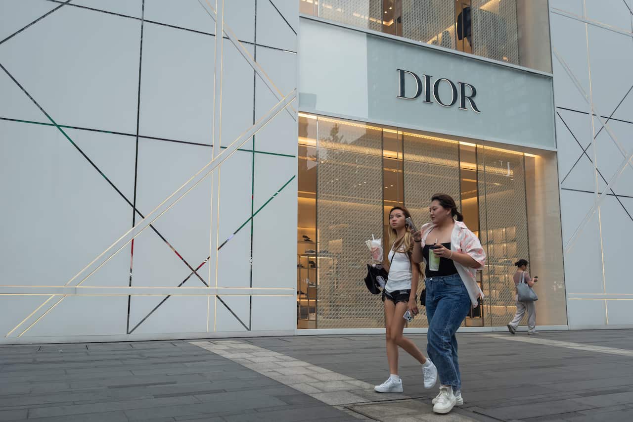 Two young Chinese women walk on the street
