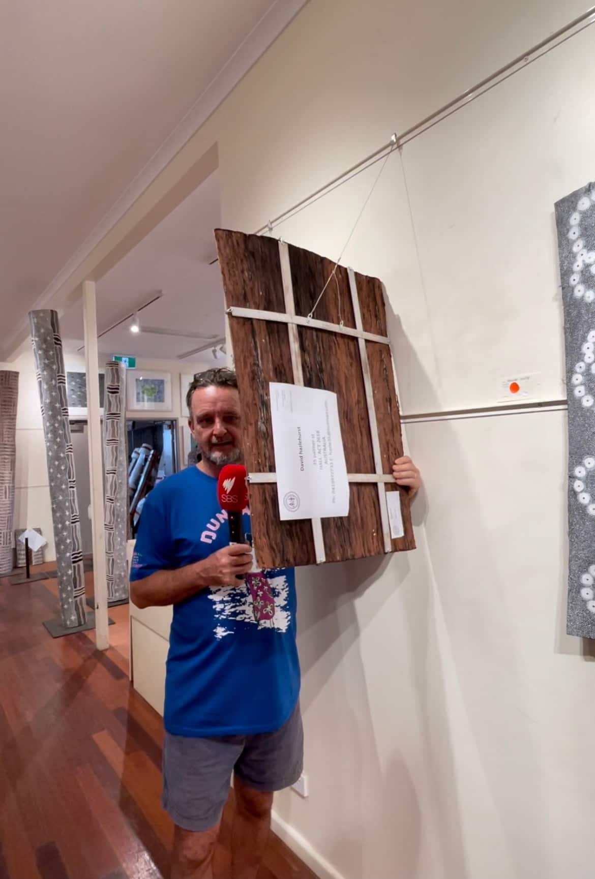 Mr. Will Stubbs showing the material of the artwork from the gallery