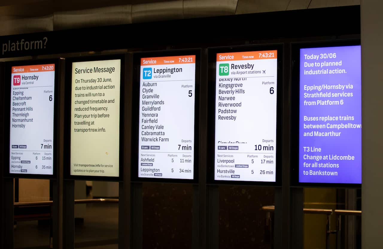 An image of train schedules at a train station in Sydney.
