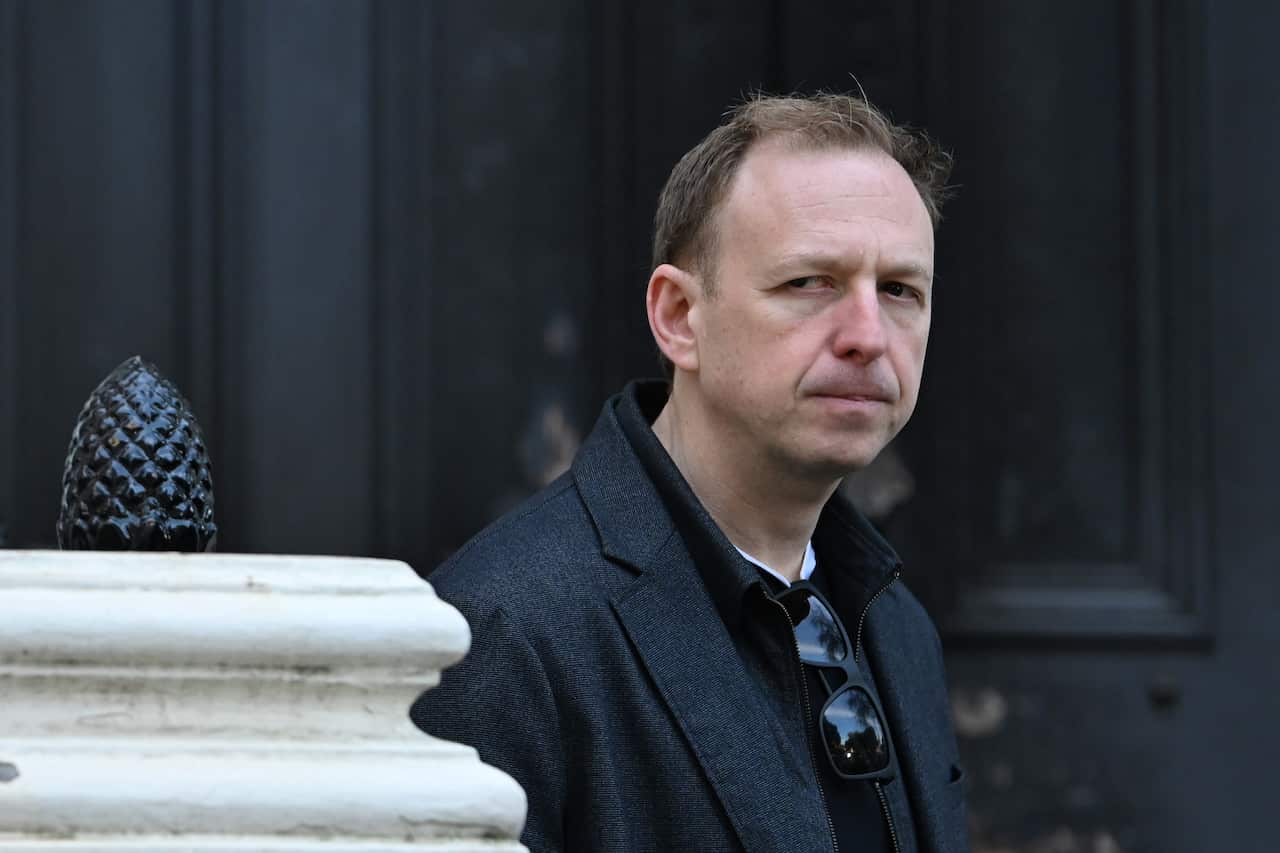 A middle-aged white man looks on