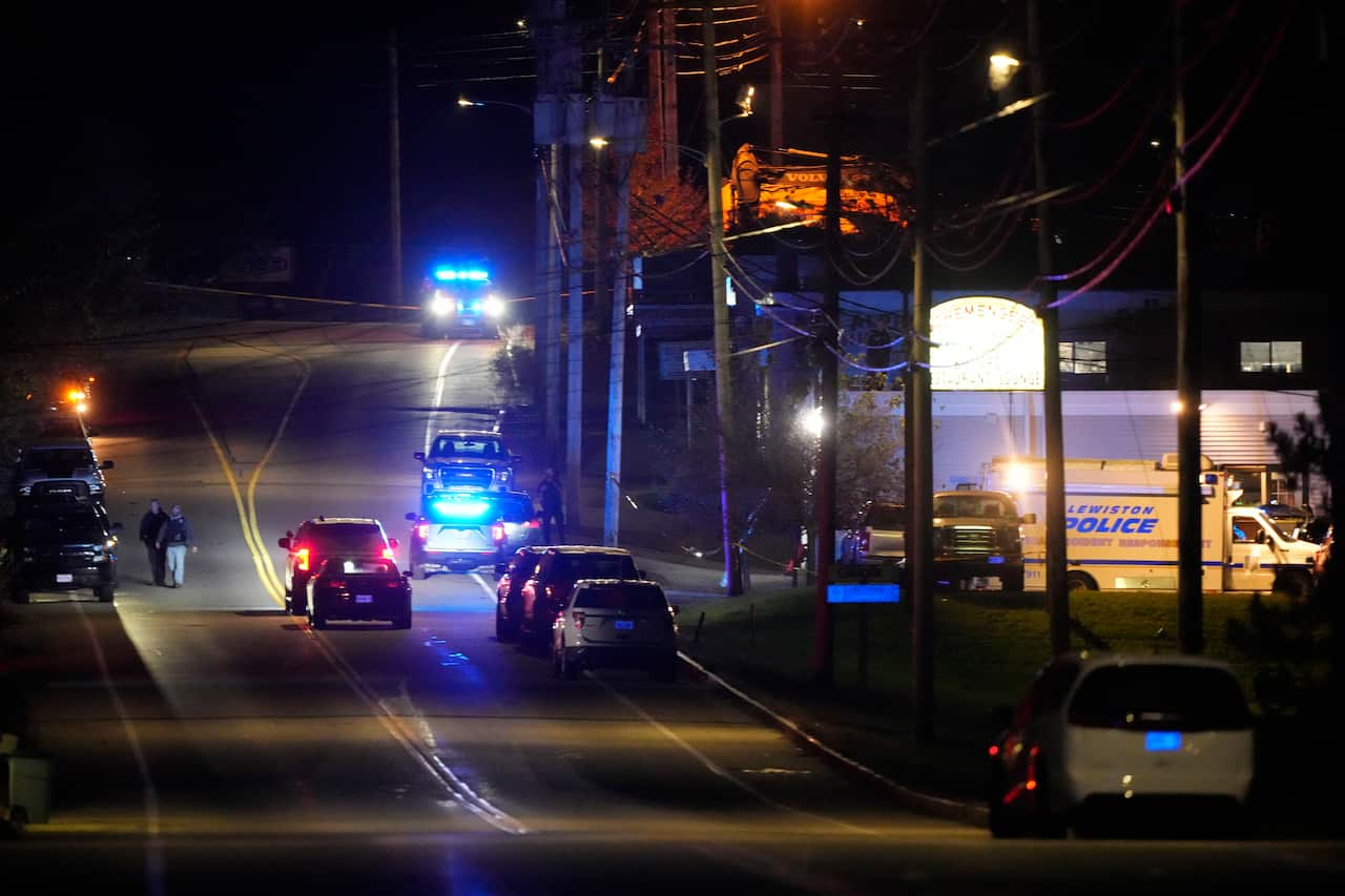 A street at night with vehicles driving on it