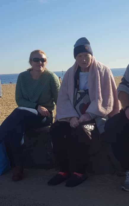 Megan and her father sitting at the beach