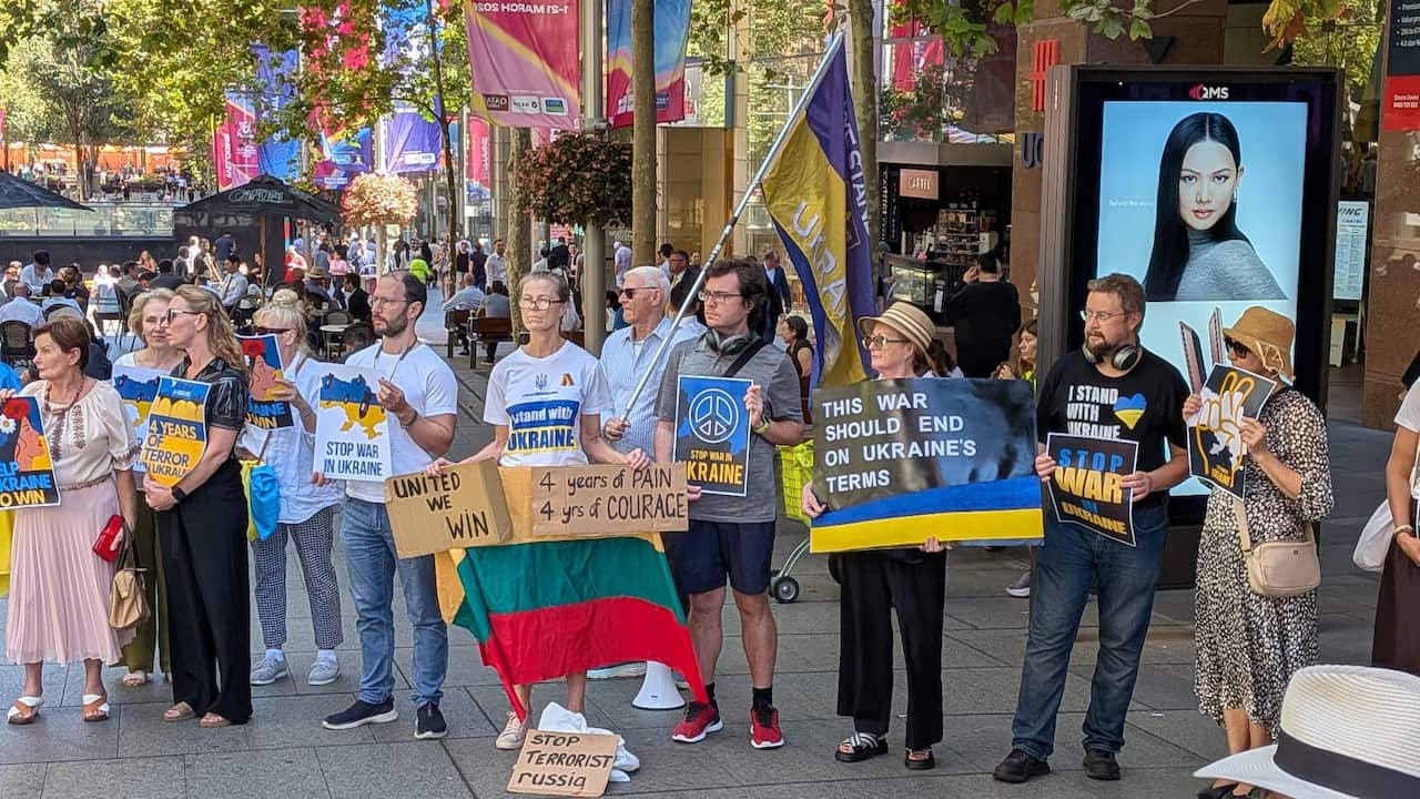 People with Ukrainian flags at a rally