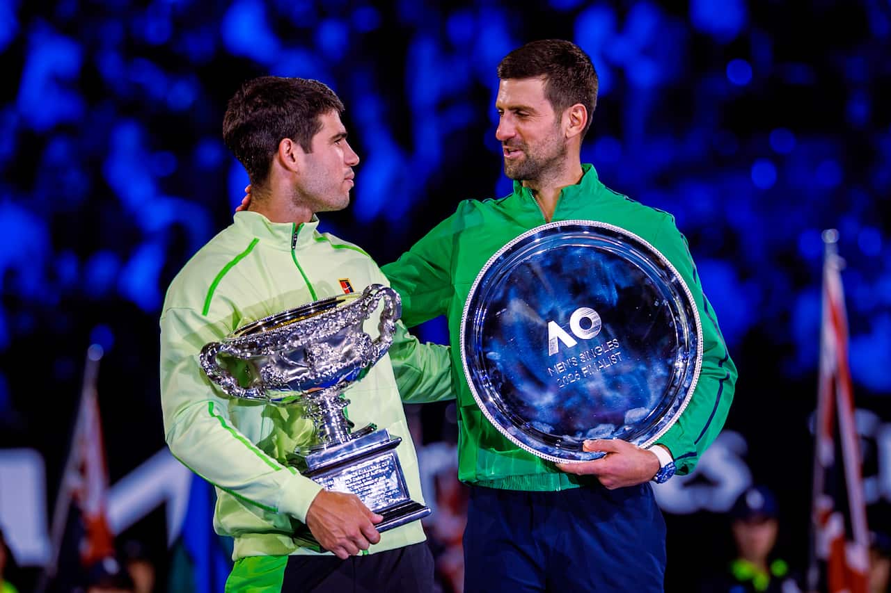 Carlos Alcaraz and Novak Djokovic with trophies