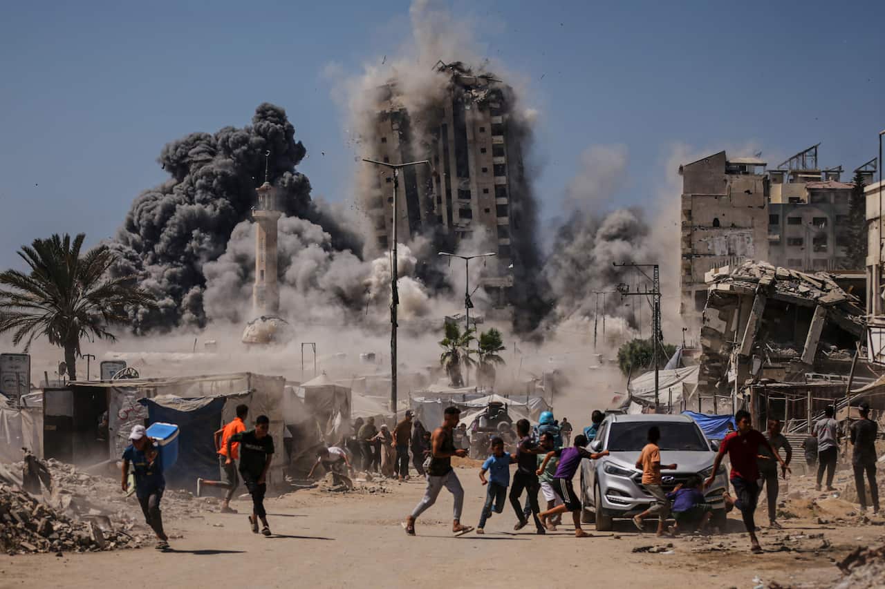 People running away from collapsing buildings