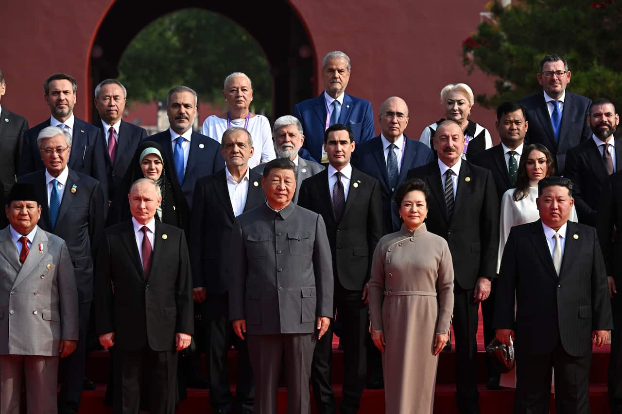 Leaders in formal attire stand in rows for a picture.