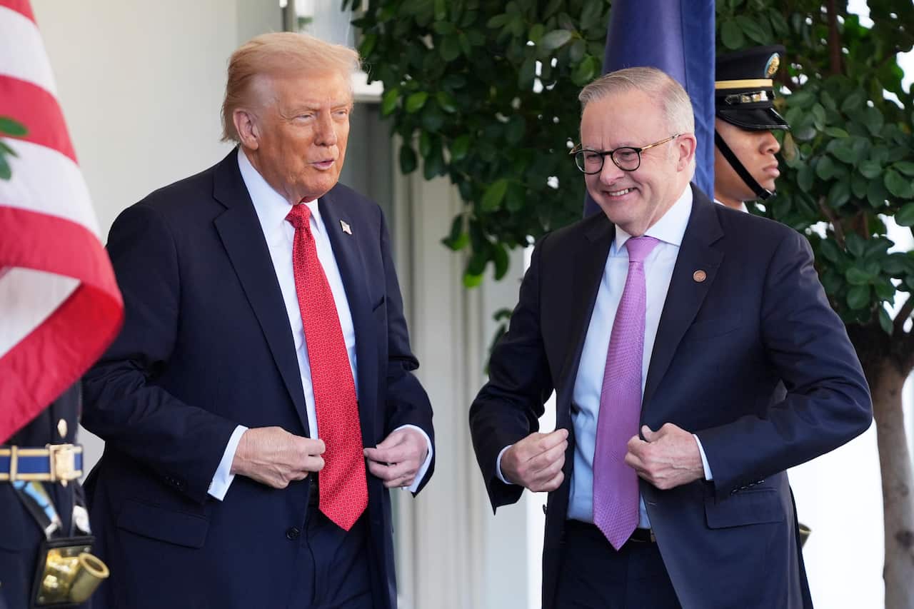 Donald Trump and Anthony Albanese are smiling as they stand next to each other.