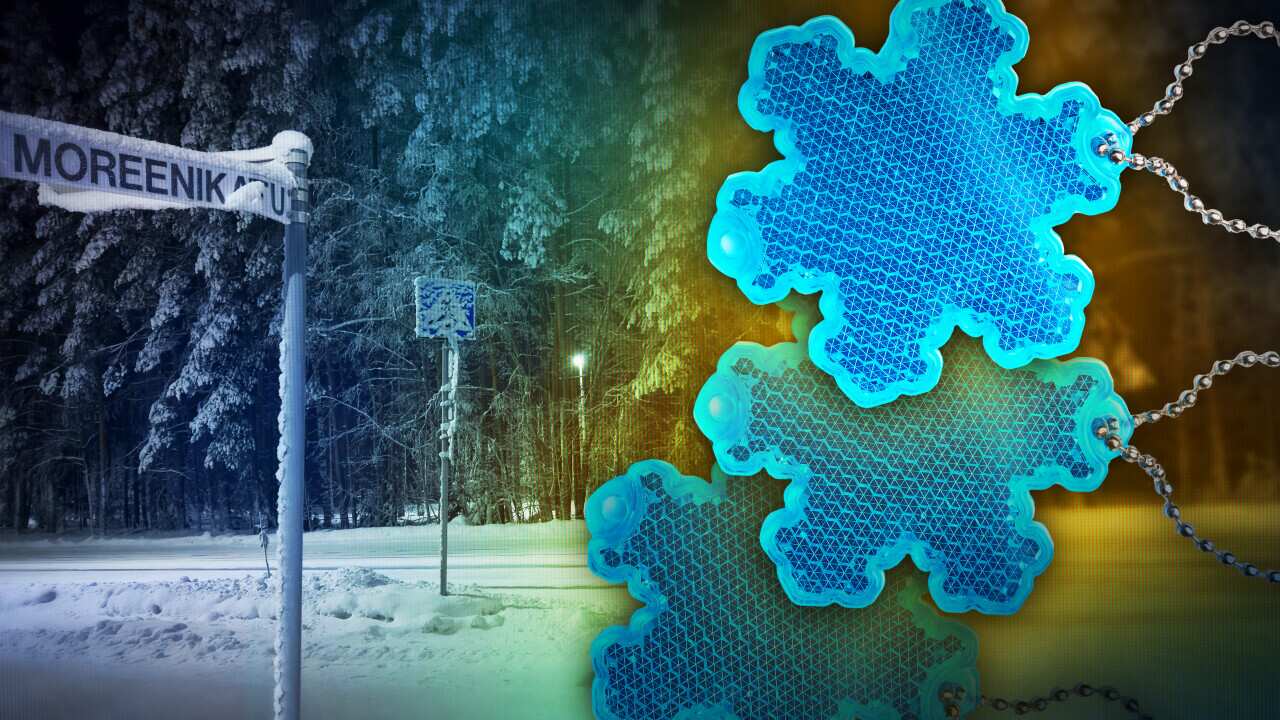 A composite image of a road sign covered in snow with an image of snowflake-shaped reflectors over the top.