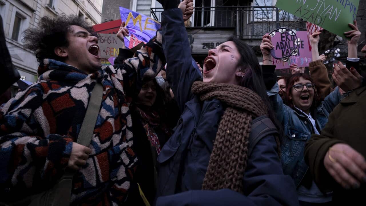 Women hold slogans during a march marking the International Women's Day near Taksim square in Istanbul.
