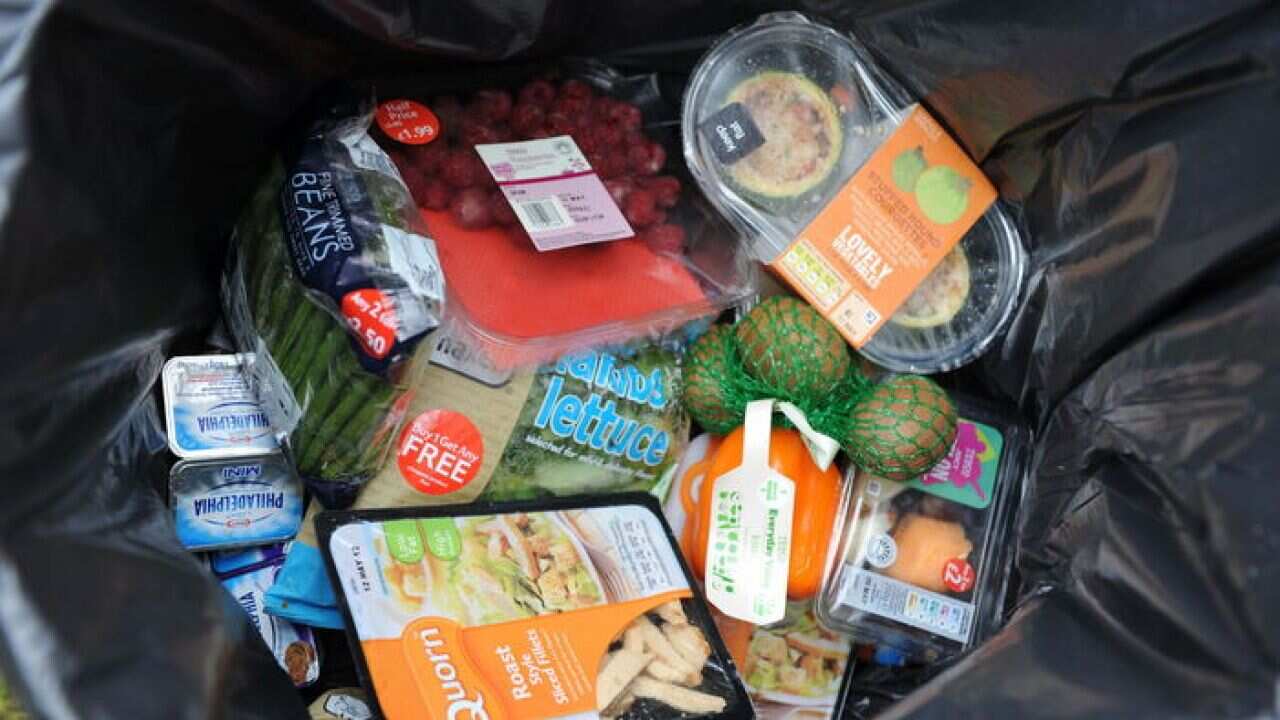 Out of date and unopened food from a domestic household thrown away in a dustbin