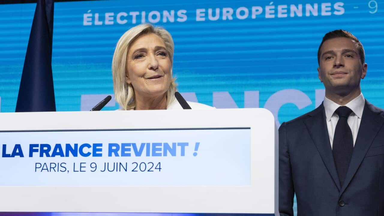 National Rally parliamentary party leader Marine Le Pen delivers a speech next to leader Jordan Bardella