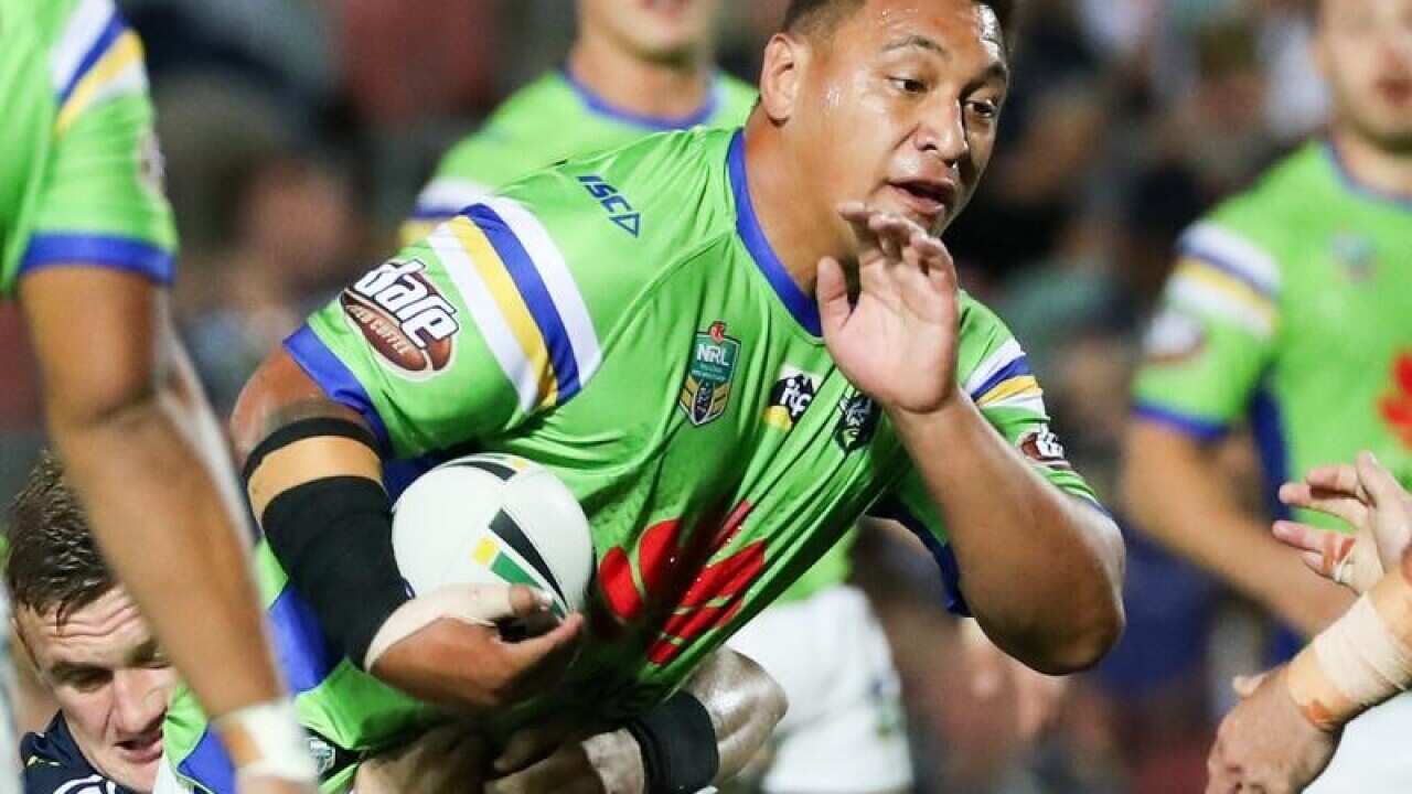 Josh Papalii of the Raiders is tackled by Coen Hess.