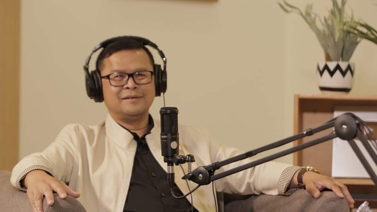 Epidemiologist Dr dr Dicky Budiman in his study making his podcasts, 2024. Photo: Supplied - Private Collection.
