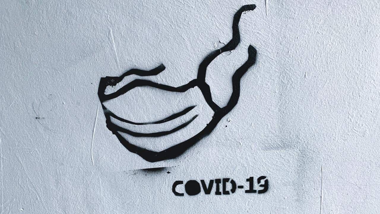 Street art - graffiti with facial mask on the wall during the current Coronavirus (COVID-19) pandemic in Warsaw, Poland