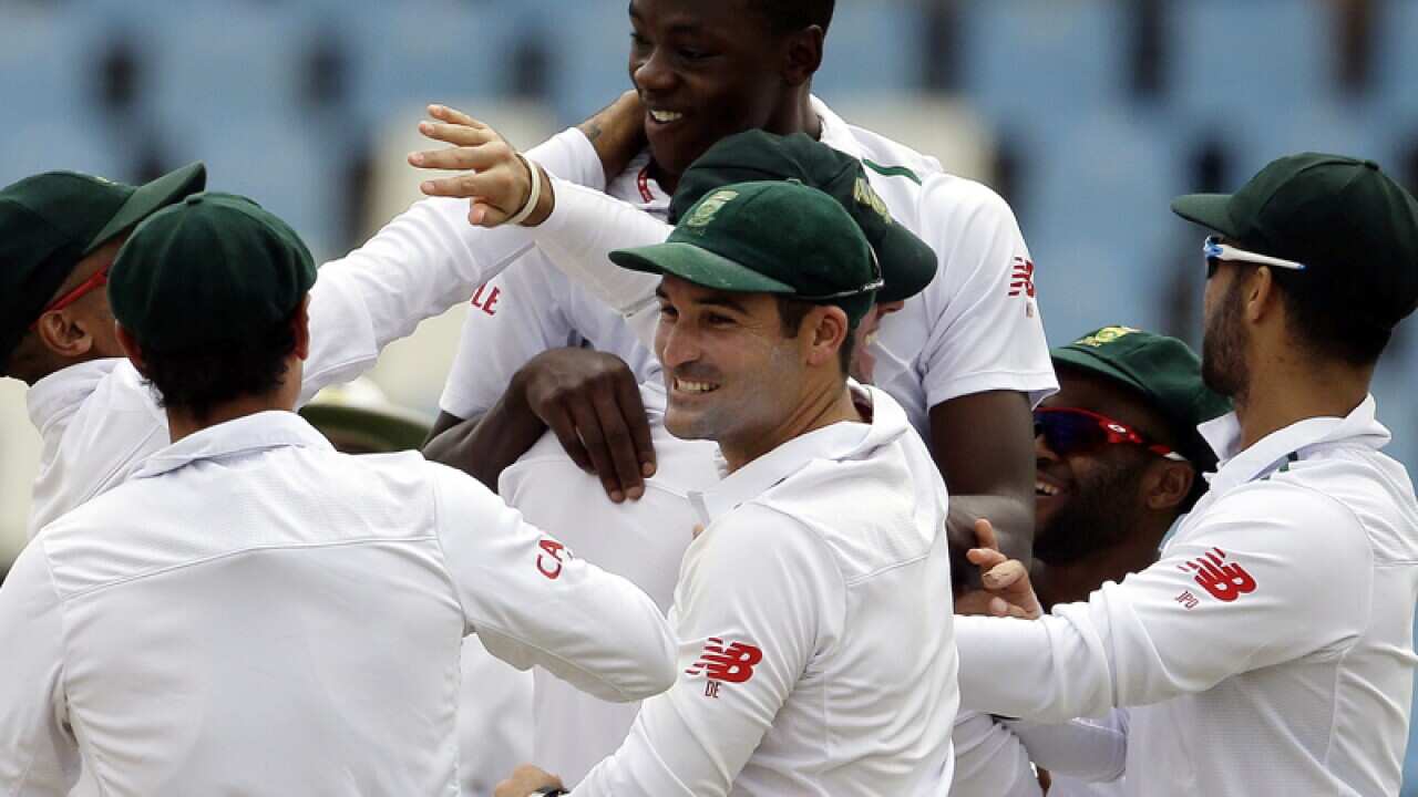 South Africa’s bowler Kagiso Rabada, top, celebrates with teammates