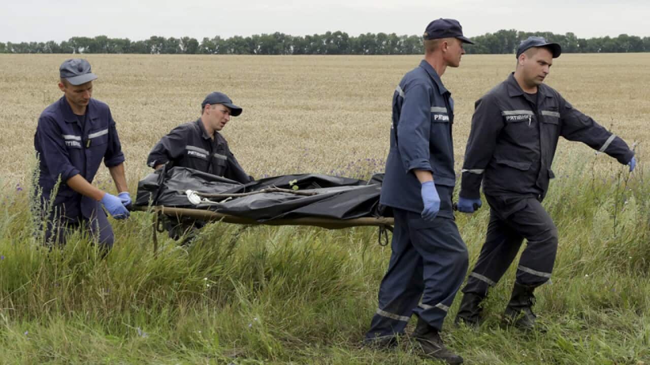 Rescuers carry bodies of passengers on a stretcher