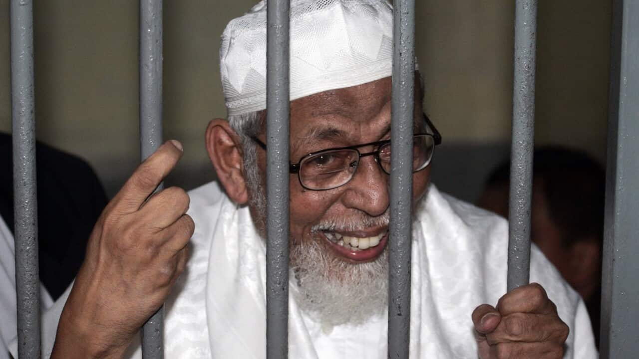 Radical cleric Abu Bakar Bashir behind bars before the start of his trial at a district court in Jakarta, Indonesia.
