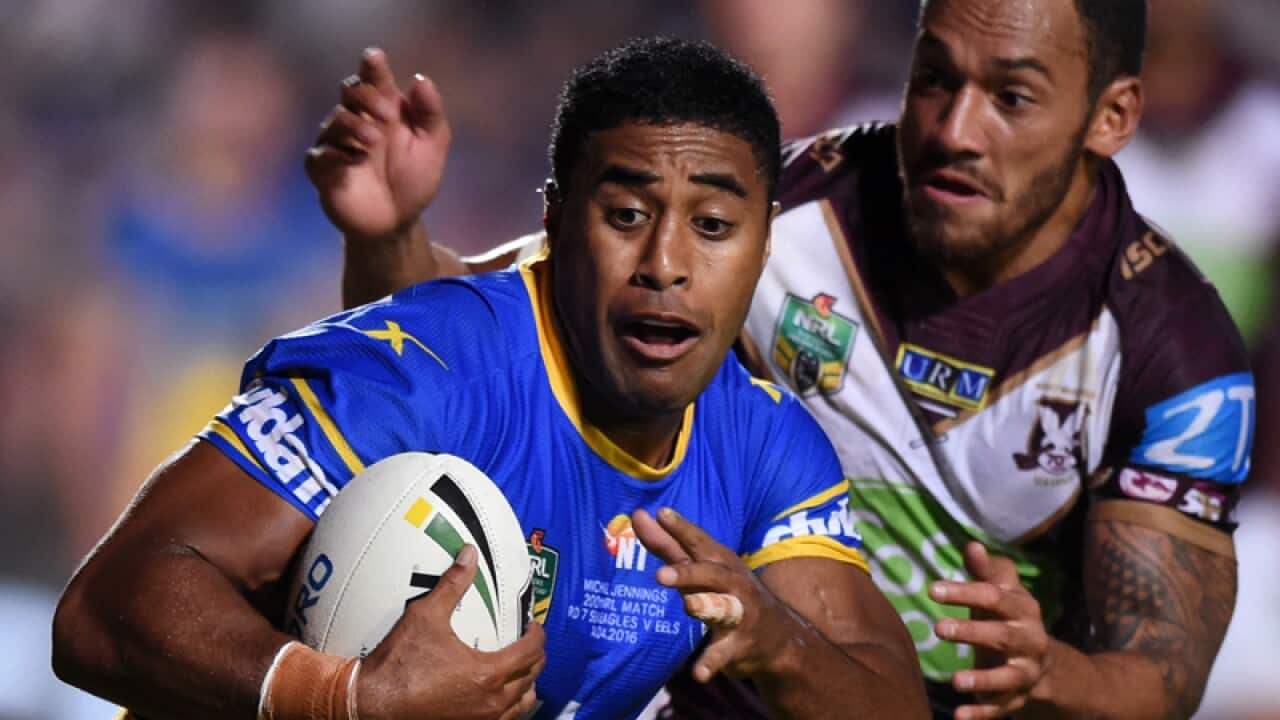 Michael Jennings (left) of the Eels is tackled by Apisai Koroisau
