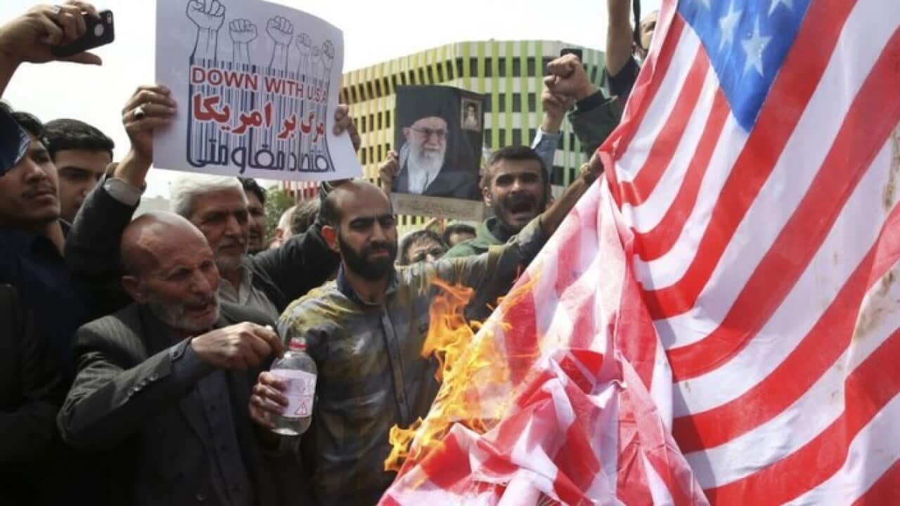 Iranian protesters burn a representation of a U.S. flag during a gathering after their Friday prayer in Tehran, 11 May 2018.