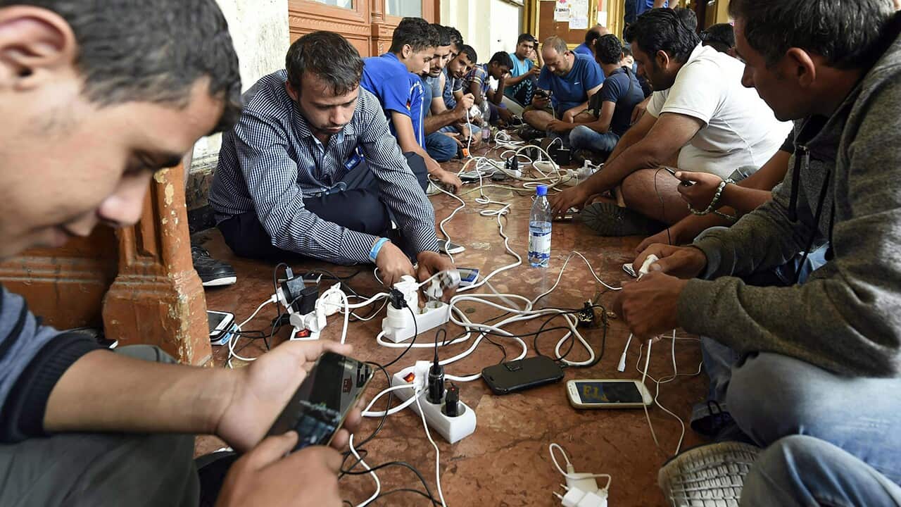 Migrants charge their phones at Keleti Railway Station in Budapest, Hungary.