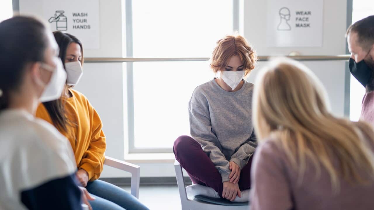 Group of people on therapy session, counselling and coronavirus concept.