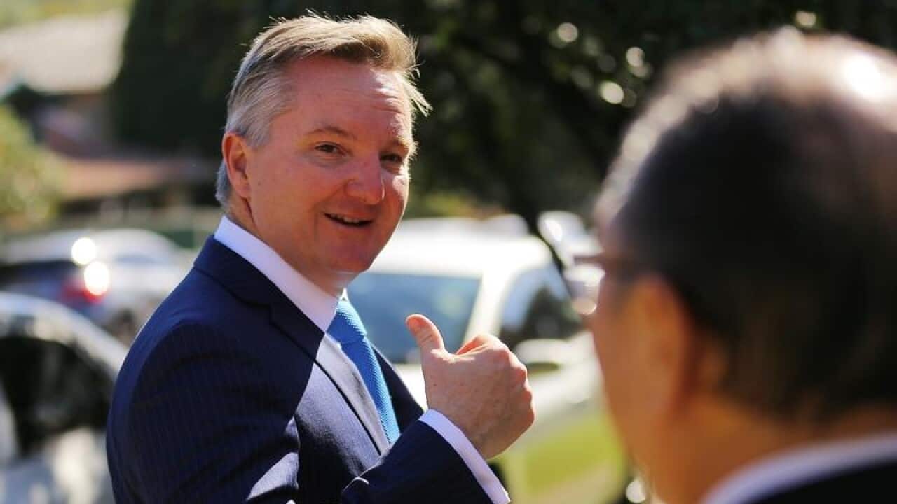 Shadow Treasurer Chris Bowen gestures before leaving a doorstop.